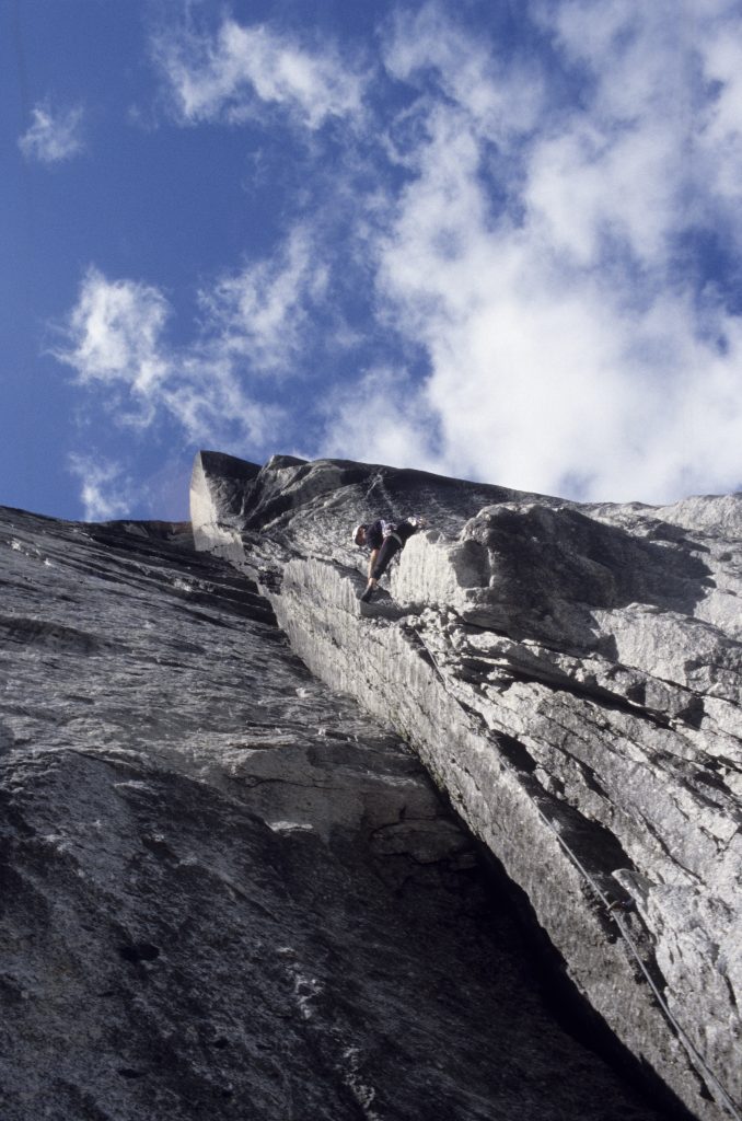 Steve Sinfield climbing the initial damp grooves pitches on the amazing 17 pitch remote wall the Lotus Flower Tower in the Cirque of the Unclimbables. In order to fix a rope to allow a speedy blast off.
