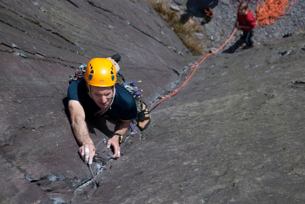 The look of frustration on the climbers face as the wire fails to fit again, on Holy, Holy Holy, E2, Dali's Hole, Slate Quarries. Come and learn how to judge gear placements on our lead climb coaching courses.