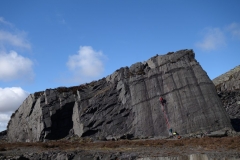 The iconic Seamstress Slab in the Dinorwic quarries, with a climber on Seamstress.