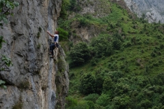A climber on a classic 6c on the right side of Urdon in the Hermida Gorge, a fantastic sports climbing venue