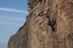 Richie Pullen on the mosdern classic Flowstone Shuffle a 6b at Peanmean Head which was only developed around 2010.