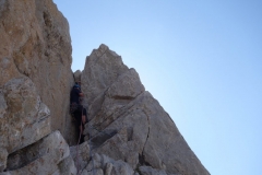 Josh Douglas on the short chimney section of pitch one of a Hard Severe that spirtals its way up a limestone tower in the High Picos Du Europa.