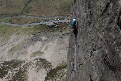 A climber powering their way up the final crack of Left Wall the ultimate E2 pitch in the Llanberis Pass.