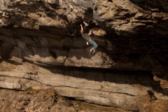 Dave Rudkin campusing the last move of Stiff Upper Lip, 8a Pigeons Cave, Great Ormes.