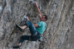 Tim Neill working his way up the Boat People a classic 7c on the Diamond.