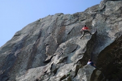 A climber having battled up the pod of Void, E4, is now faced with the boulder problem move to gain the continuation crack above!.