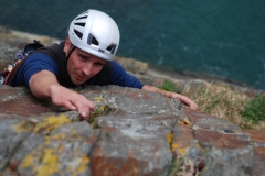 A climber tackles the top pitch of Rap at Castell Helen, opne of the classic VS's at Gogarth.