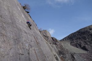 Gareth climbing the classic slate HVS Looning the Tube on one of our Private Coaching Courses, a fantastic slab with a mixture of bolts and trad gear.