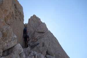 Josh Douglas on the short chimney section of pitch one of a Hard Severe that spirtals its way up a limestone tower in the High Picos Du Europa.