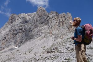 Jesse King looking up at the tower near Fuente Du in the high Picos Du Europa.