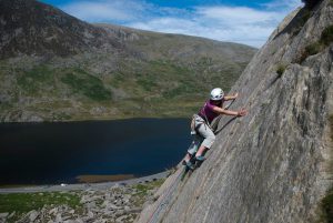 A client working on her lead climbing on the Pulpit Route, Diff, on the Milestone Buttress, Ogwen Valley.