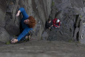 A climber on the classic open book corner of The German School Girl, E2, Rainbow Walls