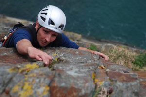A climber tackles the top pitch of Rap at Castell Helen, opne of the classic VS's at Gogarth.