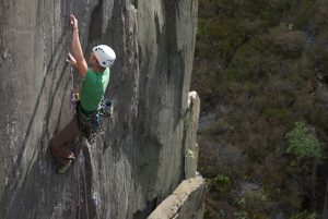 A climber powering his way up the Mau Mau, a burly E4 crack.