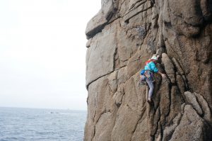 Rock Climbing on a grey day at Sennen Cove.