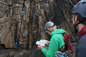 Checking out the next route whilst on our UK Trad Climbign Tour at Sennen Cove.