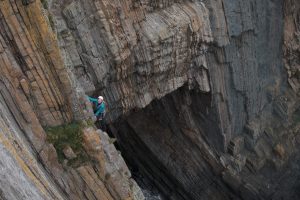 Kate Carothers on the amazing severe Shangri La at Baggy Point on our Uk Trad Tour.