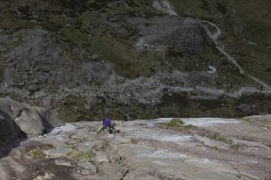 A loan scrambler soloing up Ordinary Route on Idwal Slabs.